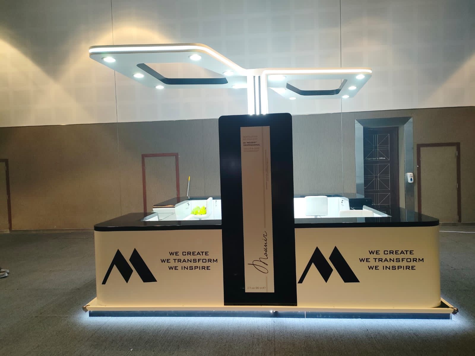 Modern retail kiosk designed by mall kiosk manufacturers in UAE, featuring branded panels and display shelves